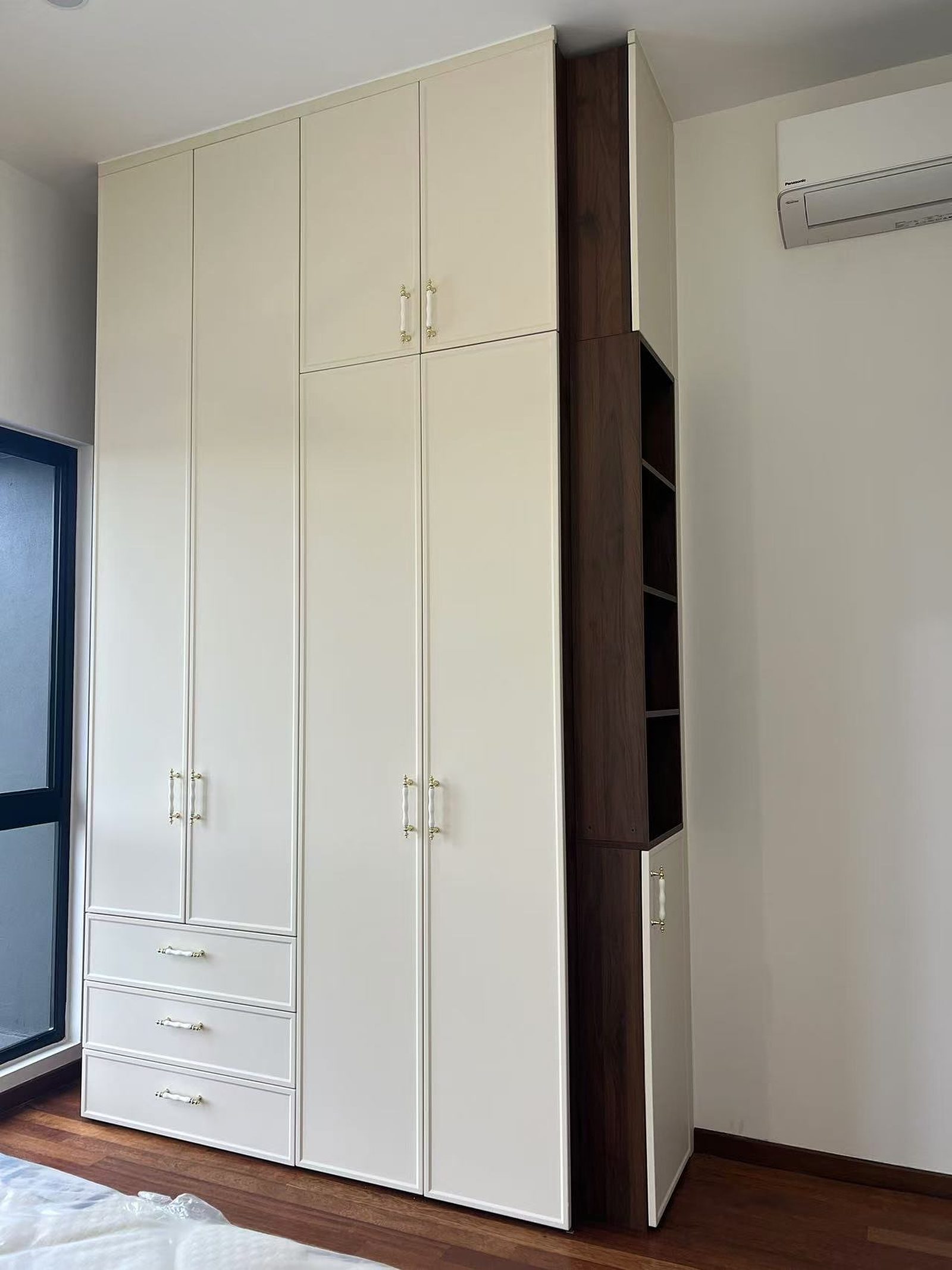 Built-in bedroom wardrobe with arched cabinet doors